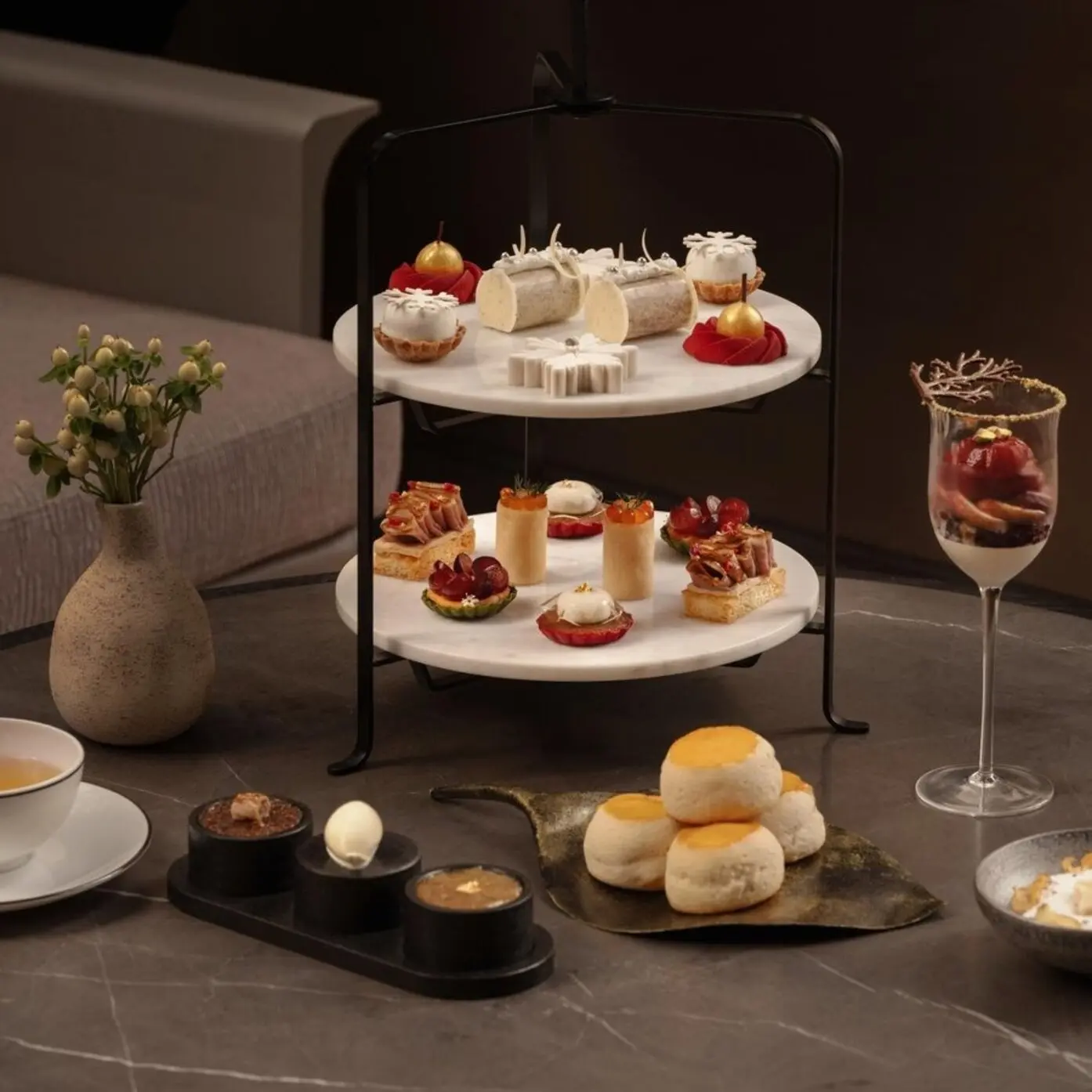 Afternoon tea stand with pastries and scones at 1872