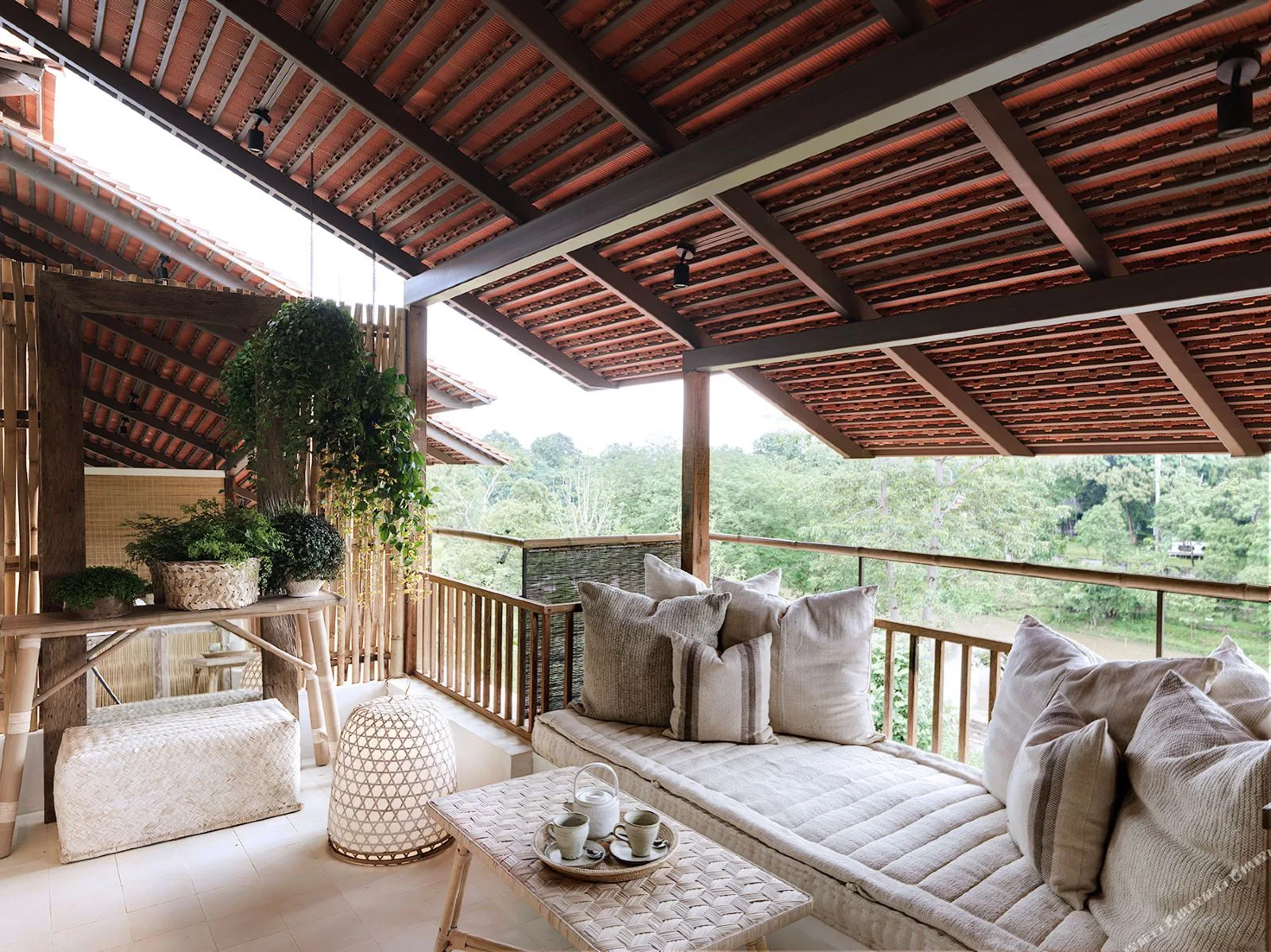 Raya Heritage &mdash; a suite terrace above the river, in rattan and raw cotton